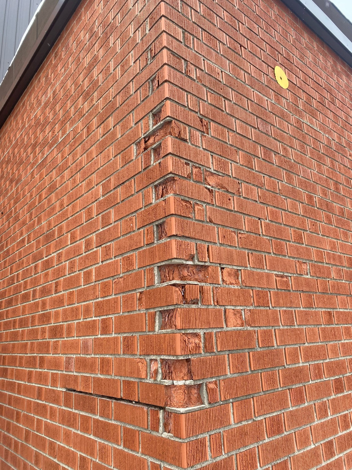 Damaged brick corner before repair